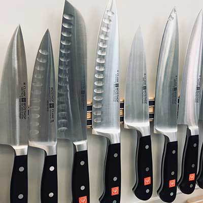 Wusthoff knives displayed against wall.